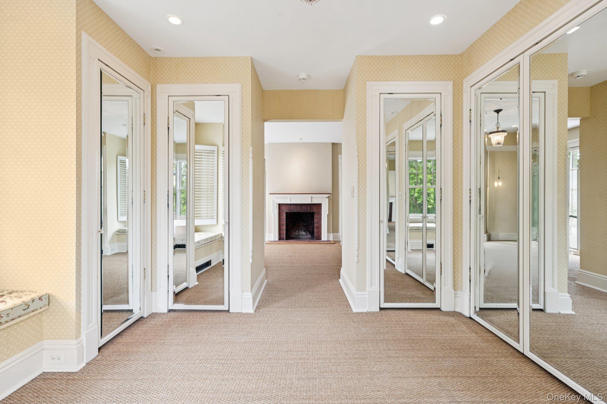 90 Thompson Avenue Babylon, NY 11702 - Photo 19 of 35 Entryway featuring wallpapered walls, carpet floors, recessed lighting, and a brick fireplace