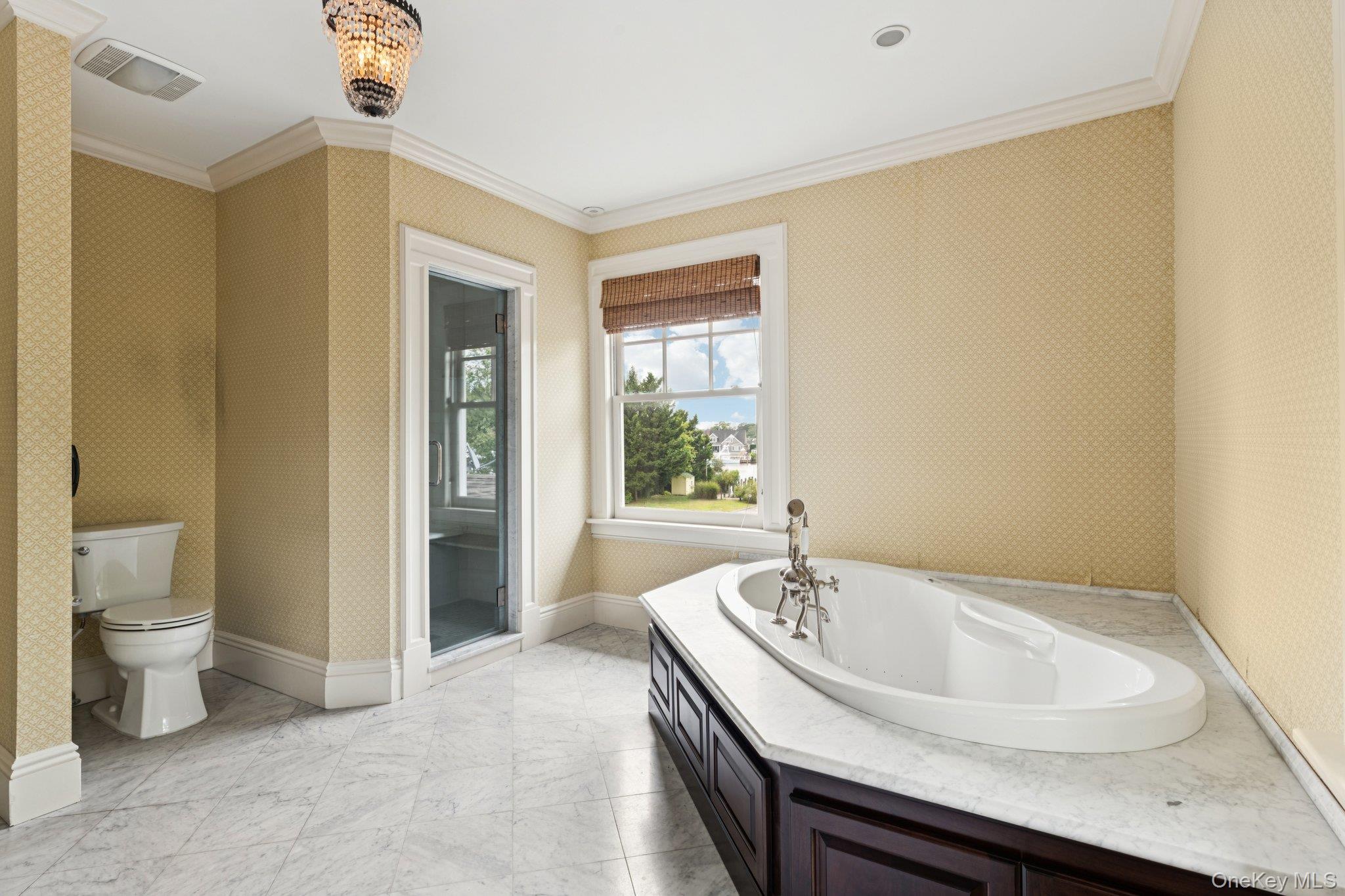 90 Thompson Avenue Babylon, NY 11702 - Photo 24 of 35 Bathroom with wallpapered walls, crown molding, and a garden tub