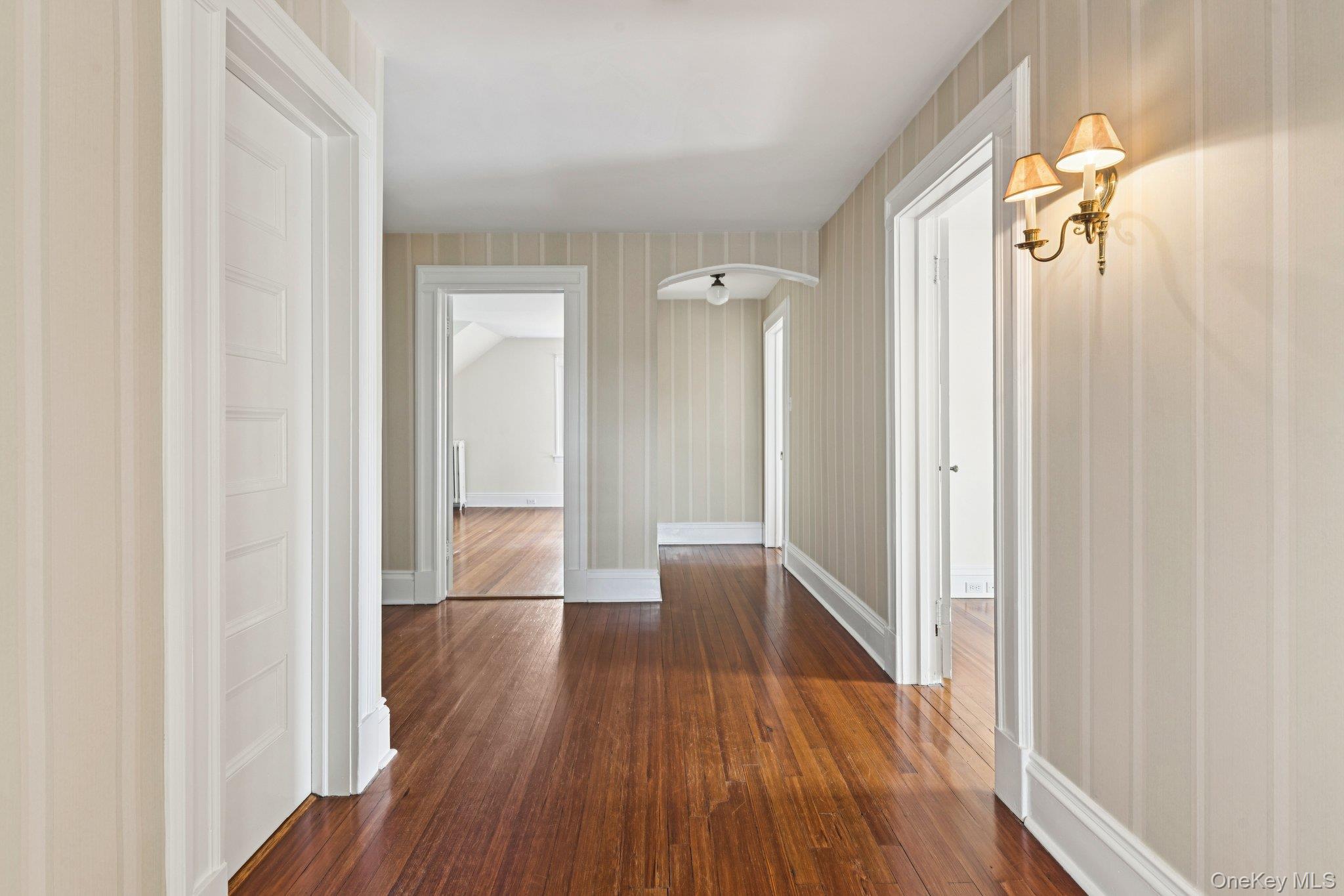90 Thompson Avenue Babylon, NY 11702 - Photo 25 of 35 Corridor featuring dark wood finished floors and arched walkways