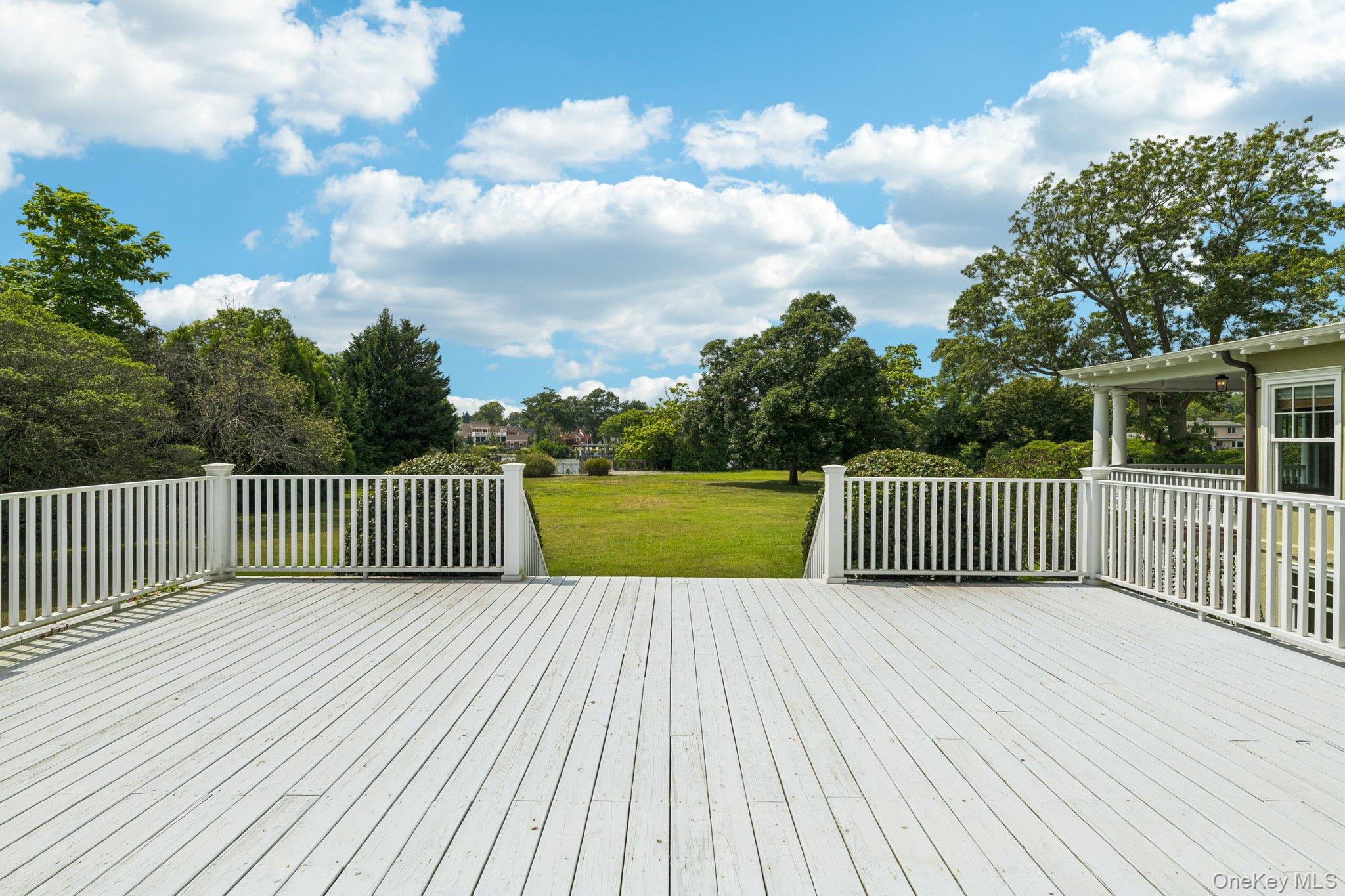 90 Thompson Avenue Babylon, NY 11702 - Photo 30 of 35 Wooden deck with a lawn and view of wooded area
