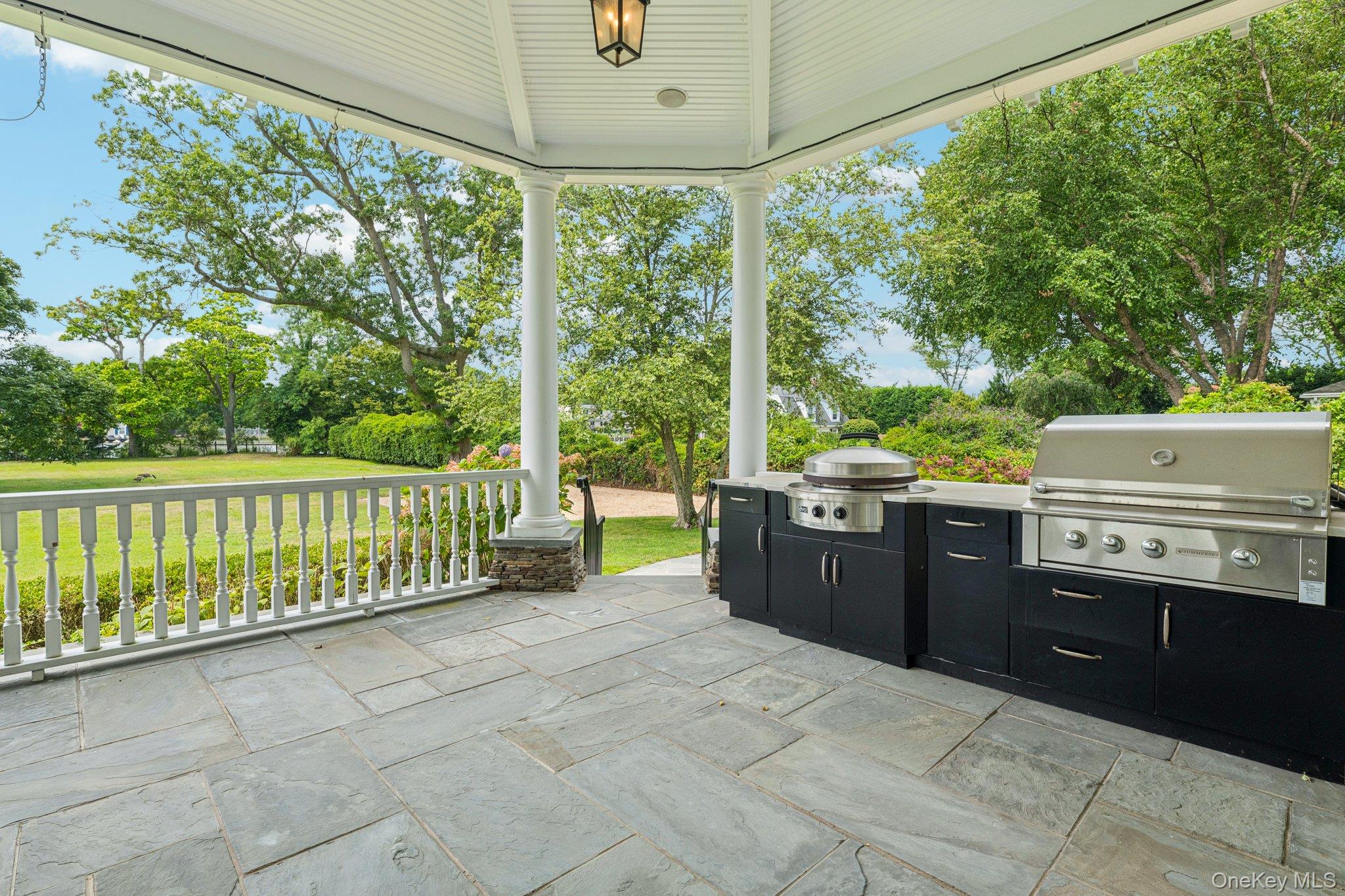 90 Thompson Avenue Babylon, NY 11702 - Photo 32 of 35 View of patio featuring area for grilling and view of wooded area