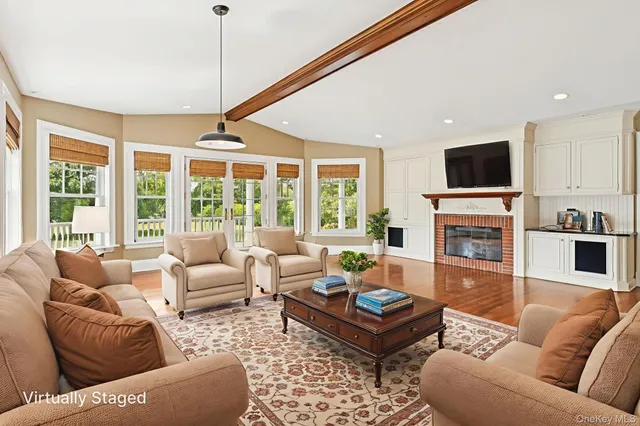a living room with fireplace furniture and a flat screen tv