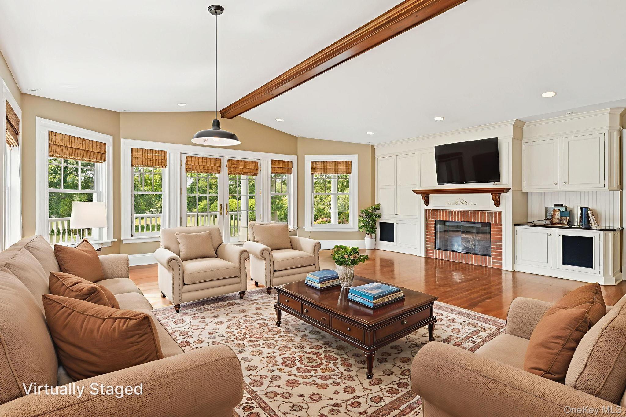 90 Thompson Avenue Babylon, NY 11702 - Photo 7 of 35 Living room with light wood-type flooring, a brick fireplace, healthy amount of natural light, and recessed lighting