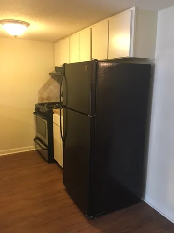 a kitchen with a refrigerator and a stove