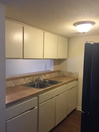 a kitchen with a sink and cabinets