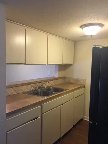a kitchen with a sink and cabinets