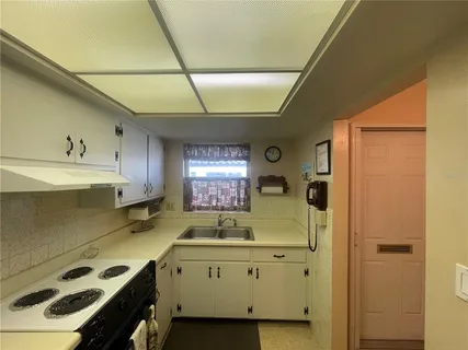 a kitchen with a refrigerator sink and stove