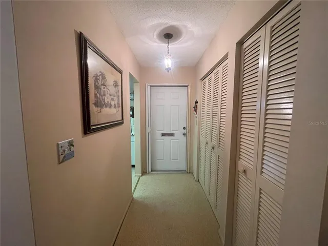 a living room with furniture a lamp and a flat screen tv