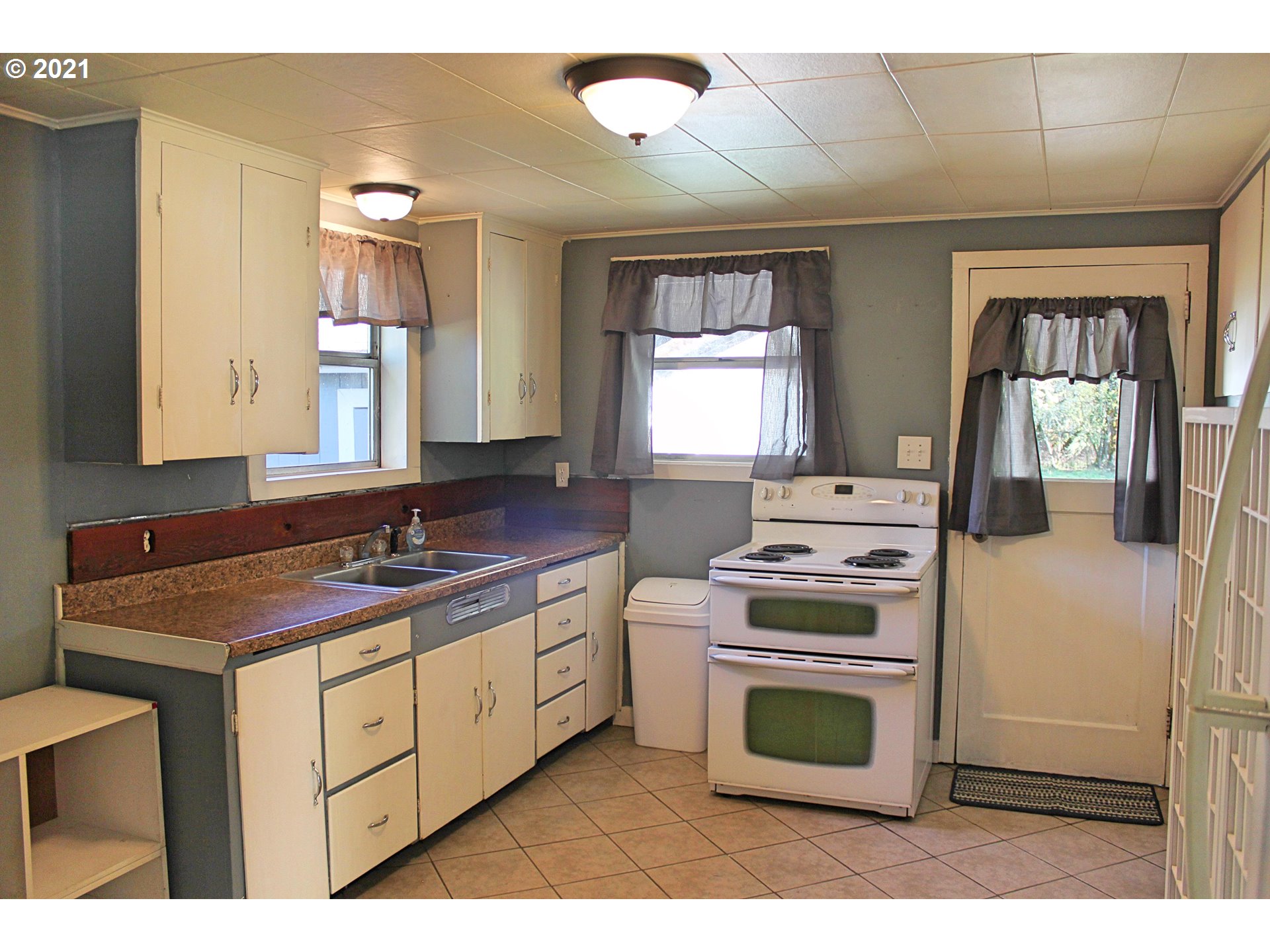 37877 Row River Road Dorena, OR 97434 - Photo 2 of 18 a kitchen with a stove top oven sink and a window