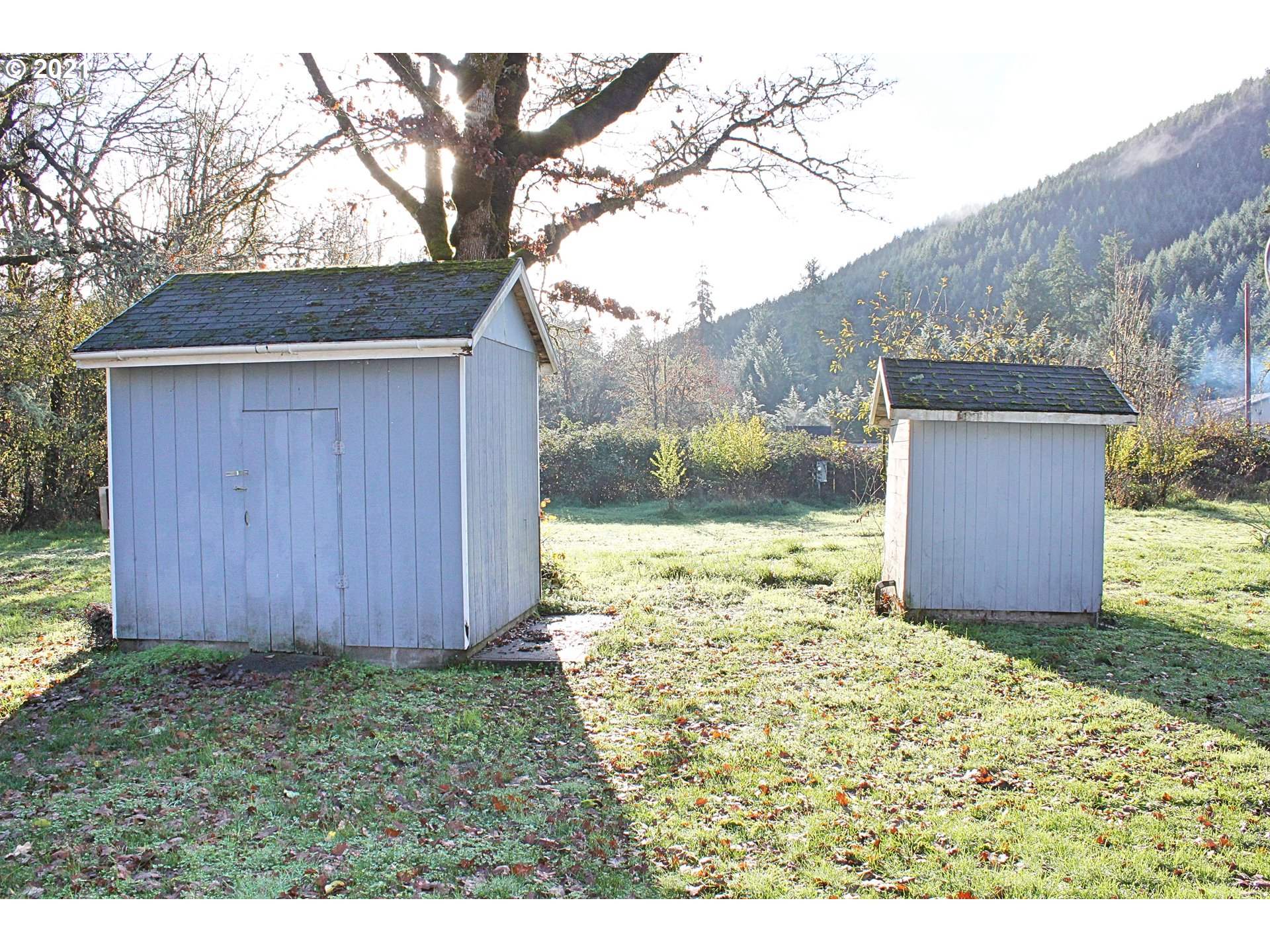 37877 Row River Road Dorena, OR 97434 - Photo 13 of 18 a view of a backyard with barn and wooden fence