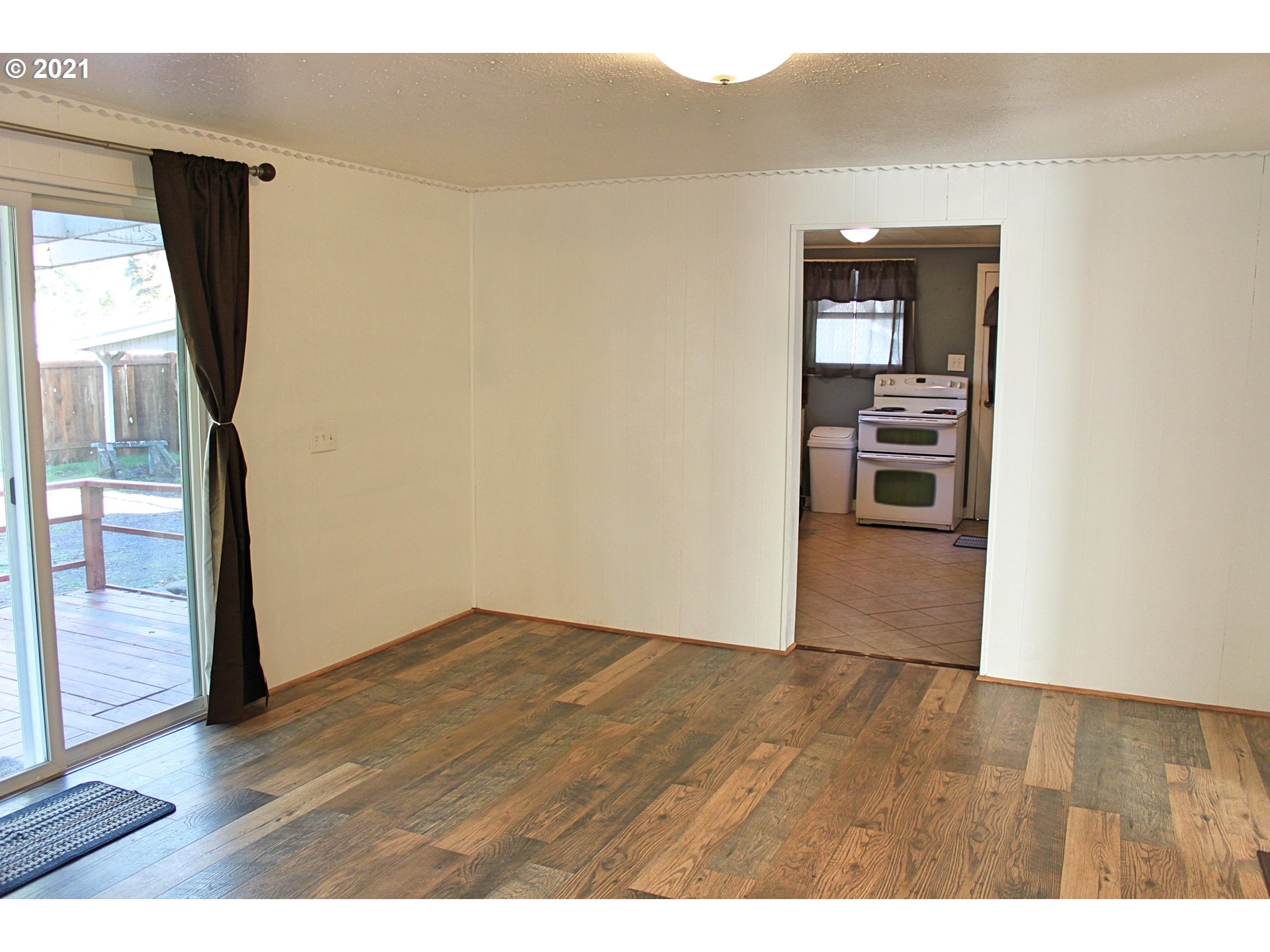 37877 Row River Road Dorena, OR 97434 - Photo 5 of 18 a view of empty room with wooden floor and cabinet