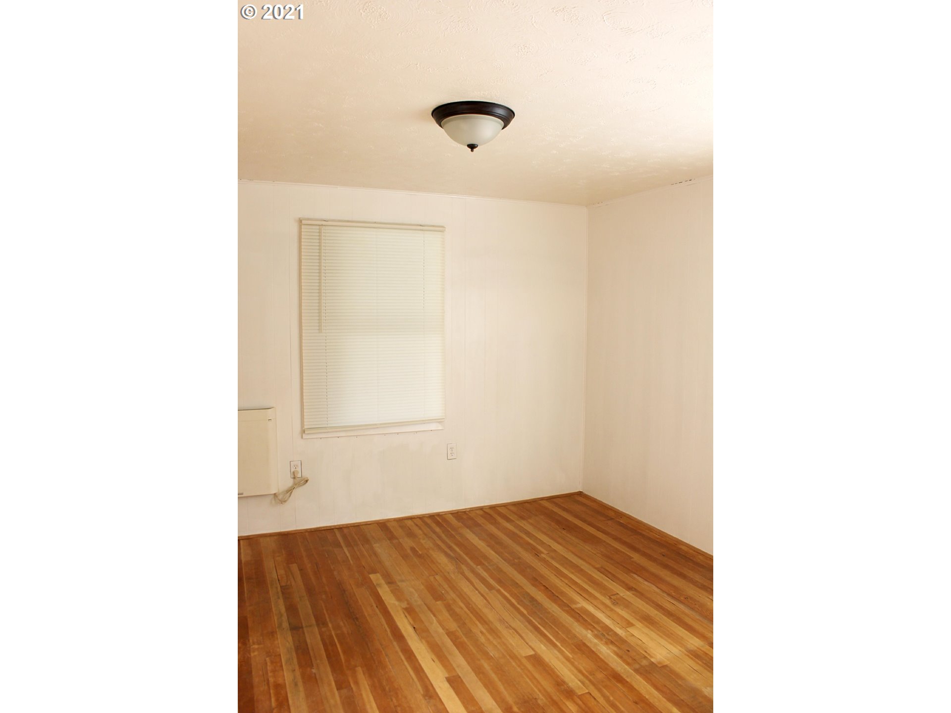37877 Row River Road Dorena, OR 97434 - Photo 9 of 18 a view of a room with wooden floor and white walls