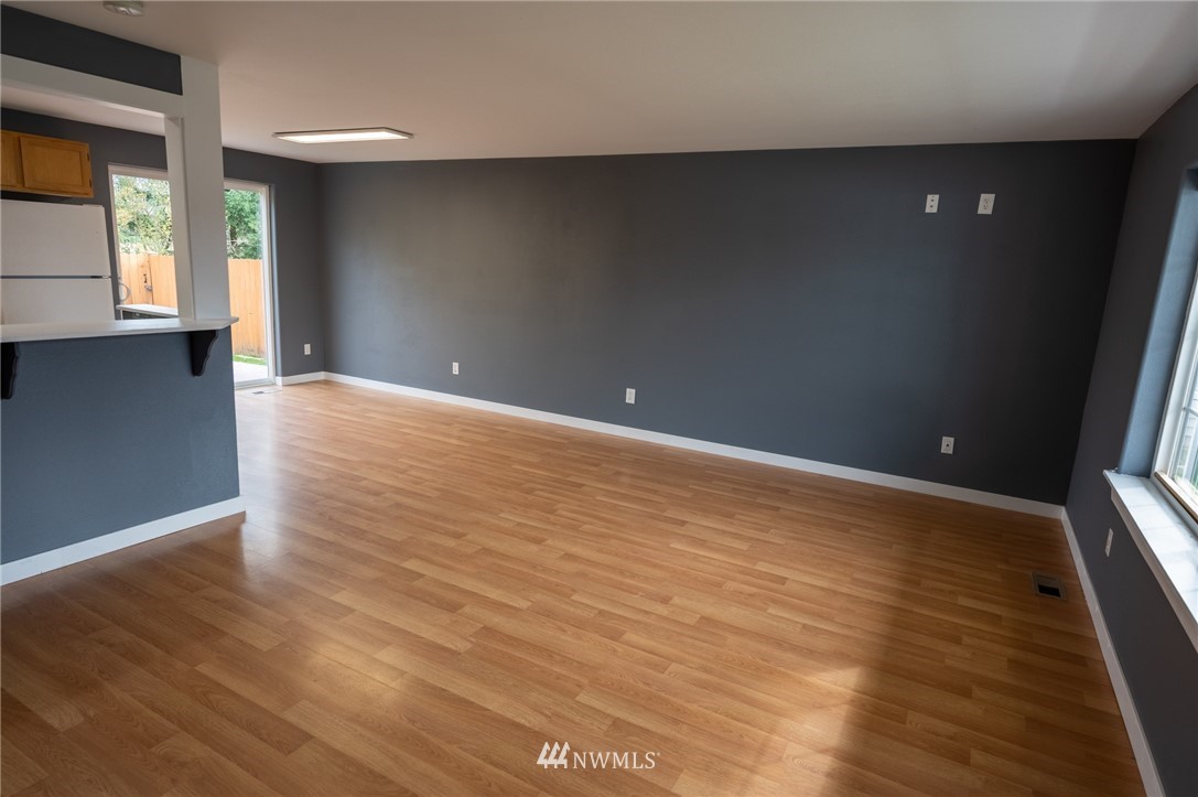 427 Rohrer Loop Sedro-Woolley, WA 98284 - Photo 4 of 36 an empty room with wooden floor and windows