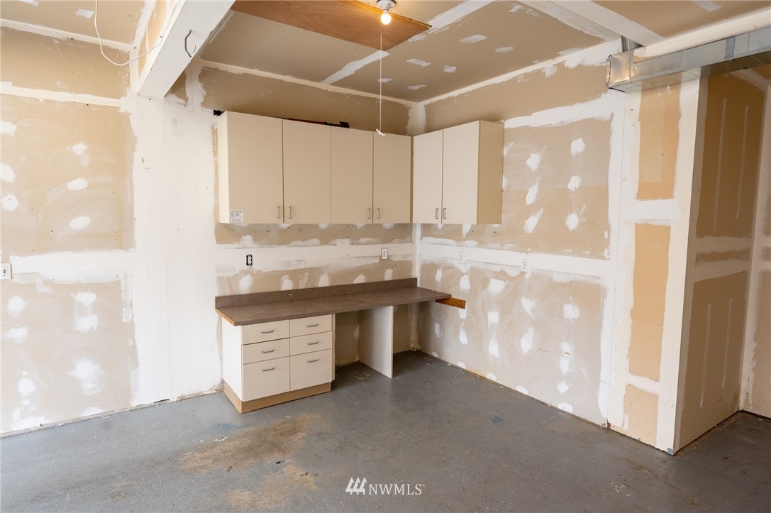 427 Rohrer Loop Sedro-Woolley, WA 98284 - Photo 32 of 36 a kitchen with granite countertop a sink and a refrigerator