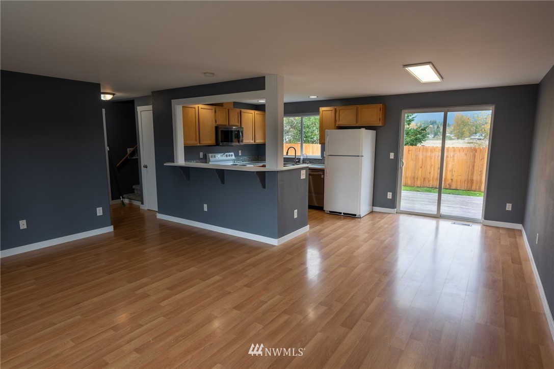 427 Rohrer Loop Sedro-Woolley, WA 98284 - Photo 5 of 36 a view of an empty room with a window and wooden floor