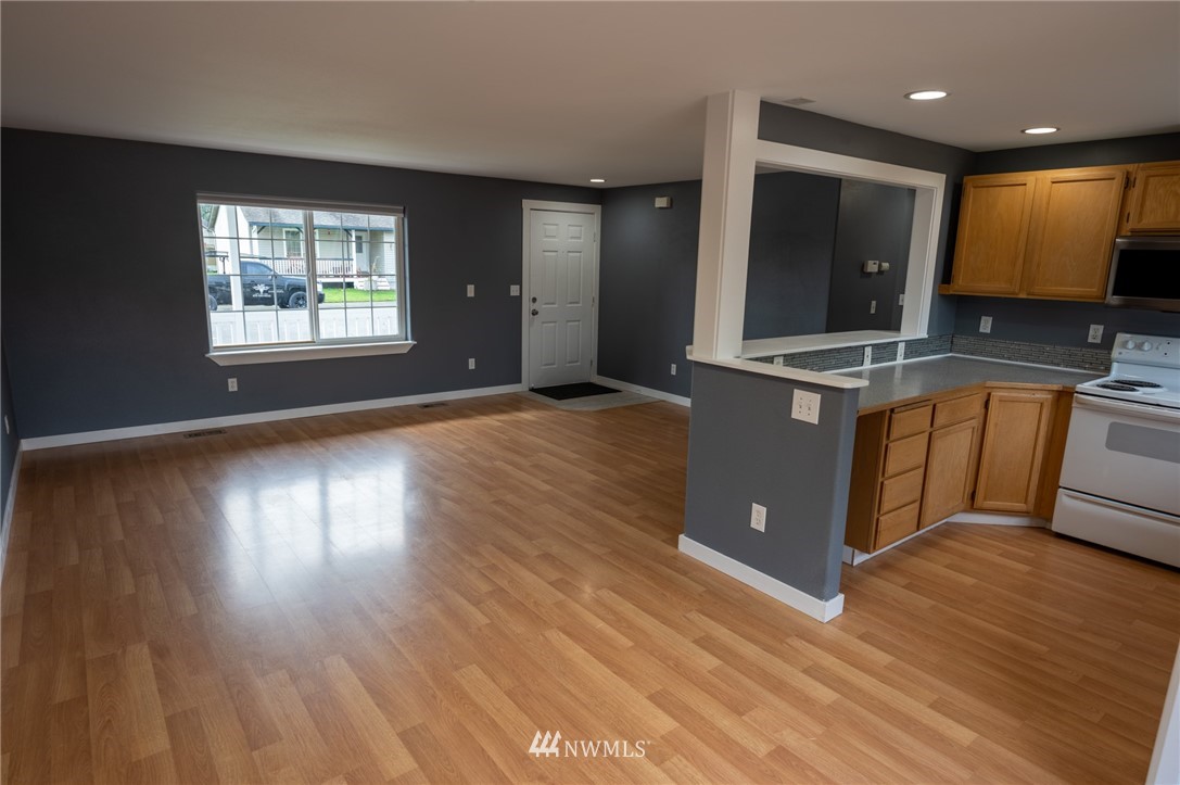 427 Rohrer Loop Sedro-Woolley, WA 98284 - Photo 7 of 36 a kitchen with stainless steel appliances granite countertop a stove a sink and a large window