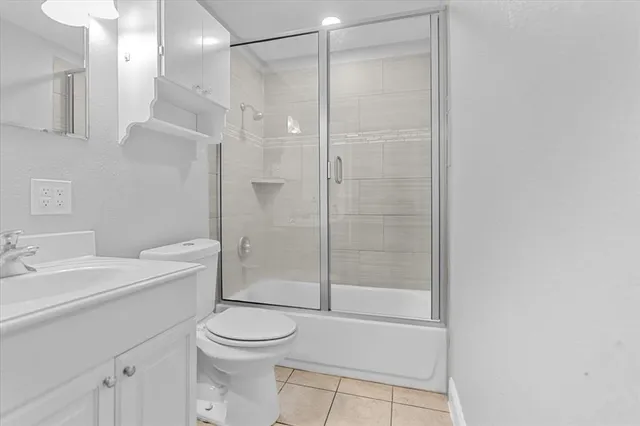 a bathroom with a shower a toilet and sink
