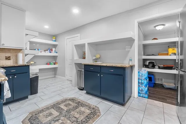 a kitchen with stainless steel appliances granite countertop a refrigerator and a stove