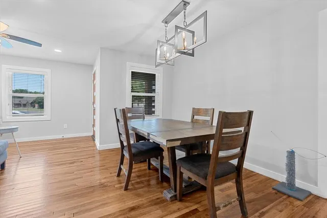 a view of a dining room with a table and chairs