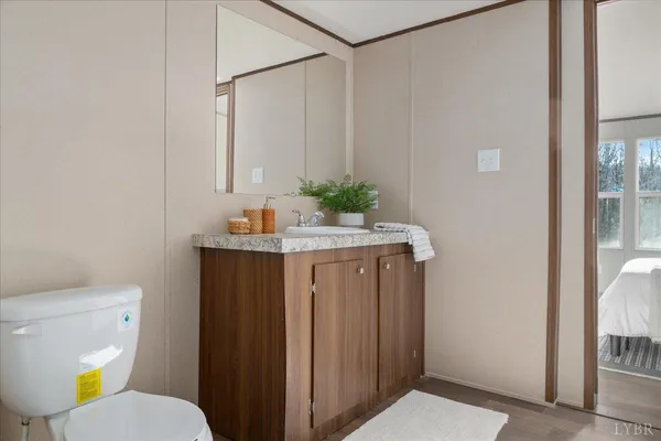 a bathroom with a sink a toilet and shower curtain