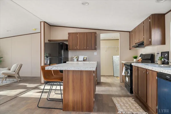 a kitchen with stainless steel appliances granite countertop a refrigerator and a stove top oven