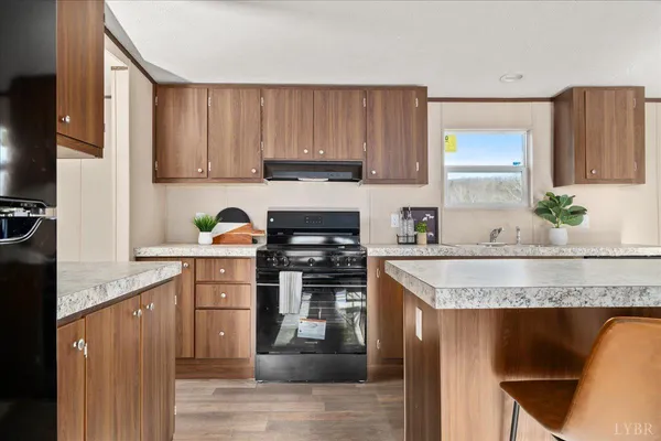 a kitchen with granite countertop wooden cabinets and white appliances
