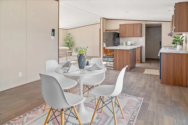 a view of a dining room with furniture and a kitchen view