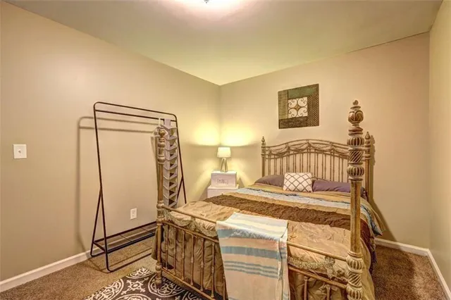 a bedroom with a bed and a mirror on the wall