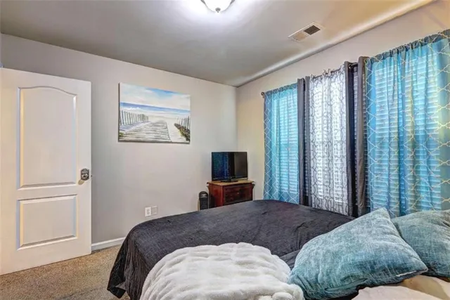 a bedroom with a large bed and a tv