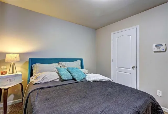 a bedroom with a bed and a lamp