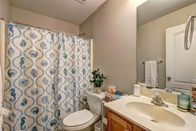 a bathroom with a sink toilet and mirror