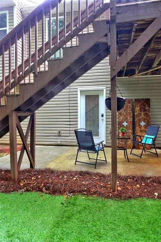 a view of an house with backyard porch and sitting area