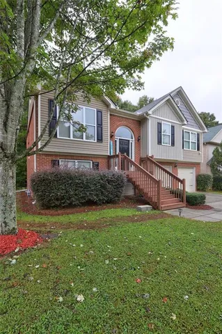 a front view of a house with a garden and deck
