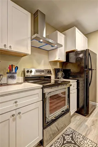 a kitchen with stainless steel appliances granite countertop a sink a stove and cabinets