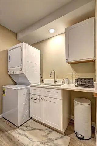 a kitchen with a sink cabinets and wooden floor