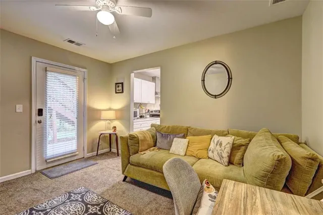 a living room with a couch and chandelier
