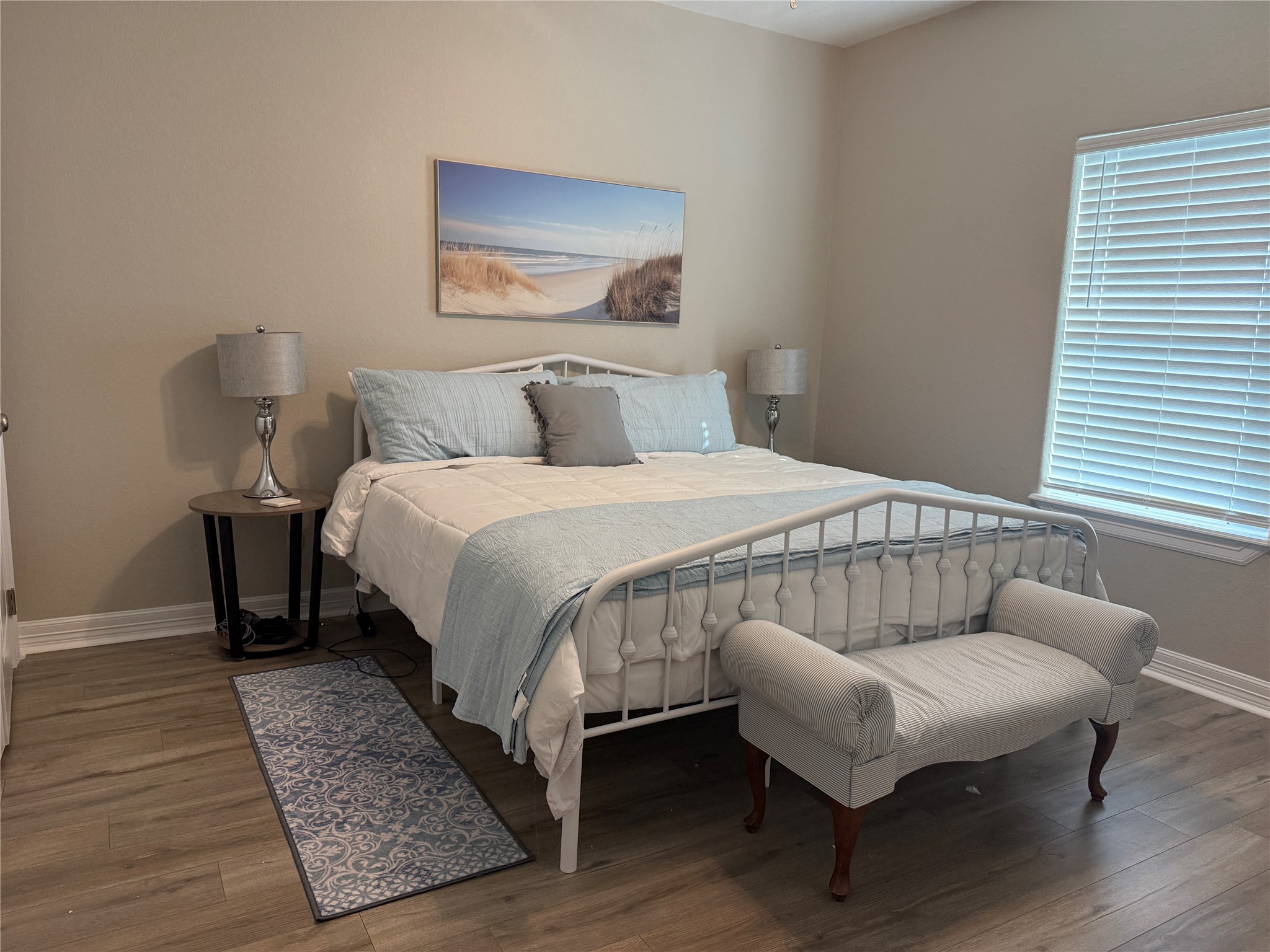 528 Thunder Road Surfside Beach, TX 77541 - Photo 19 of 22 a bedroom with a bed and wooden floor