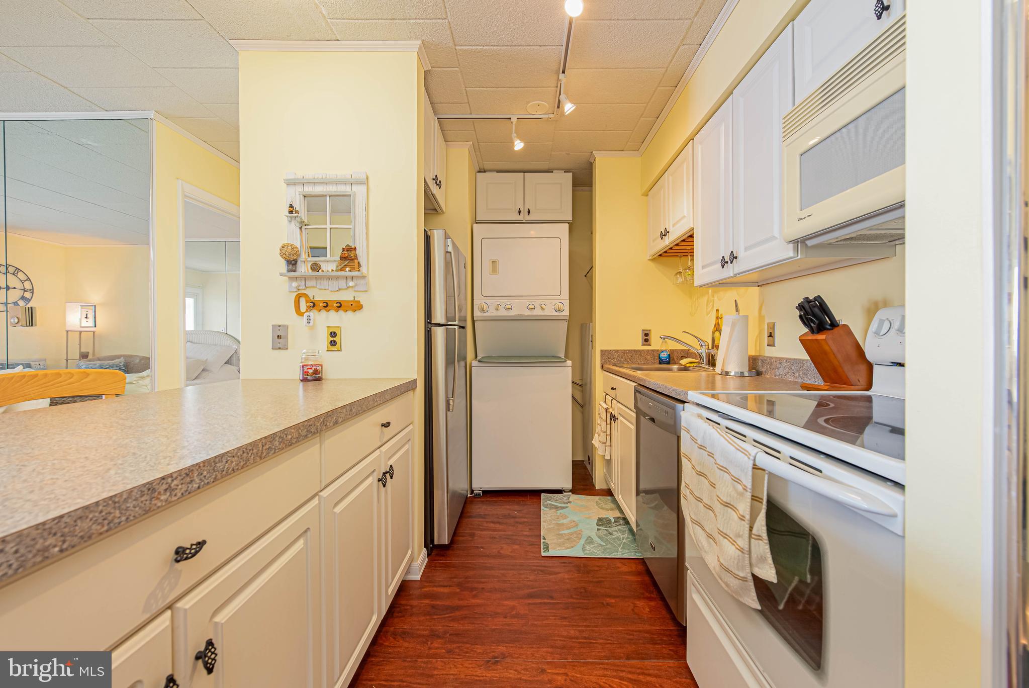 745 Mooring Road, Unit 406 Ocean City, MD 21842 - Photo 11 of 24 a kitchen with stainless steel appliances a sink and a refrigerator