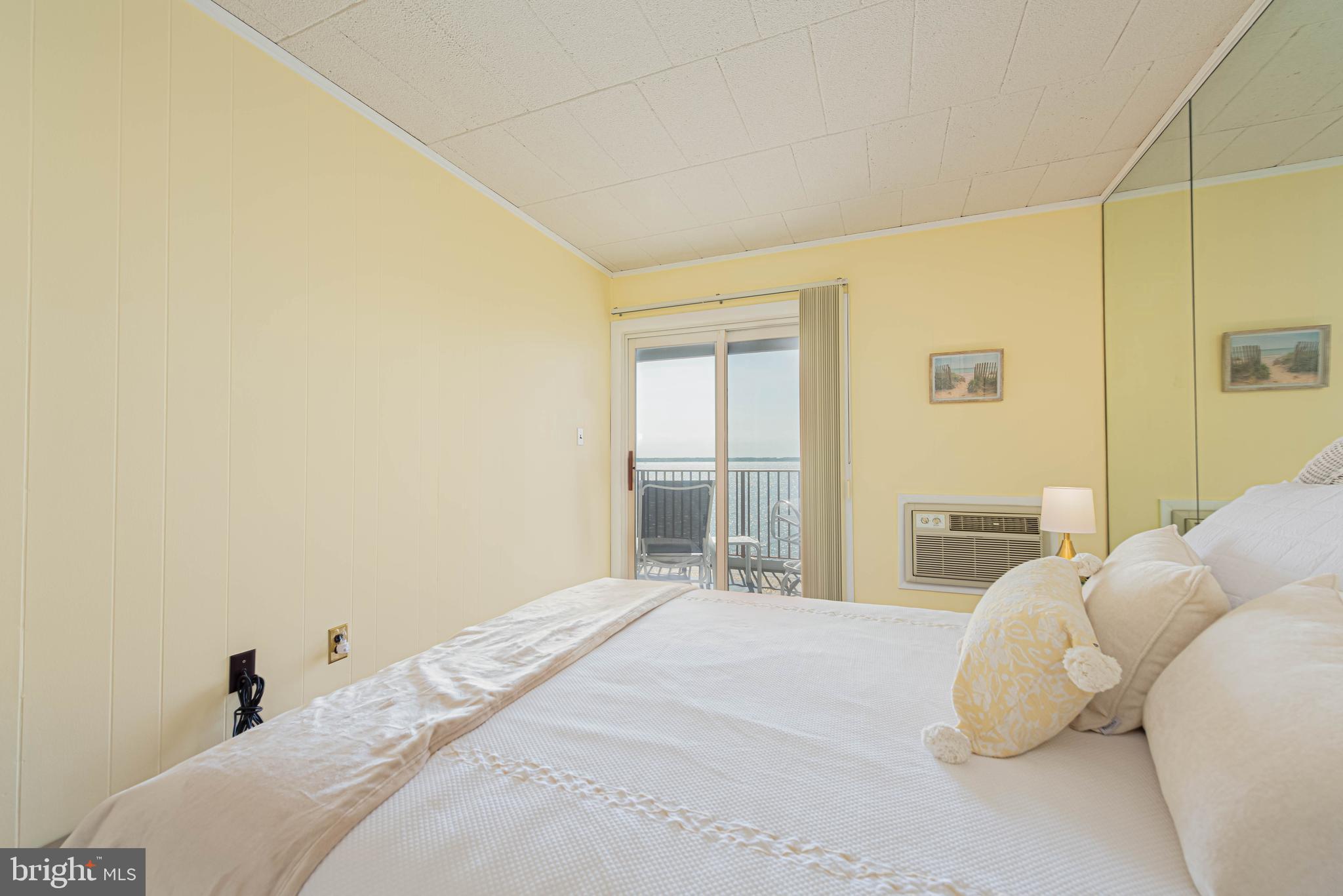 745 Mooring Road, Unit 406 Ocean City, MD 21842 - Photo 14 of 24 a bedroom with a bed and a lamp