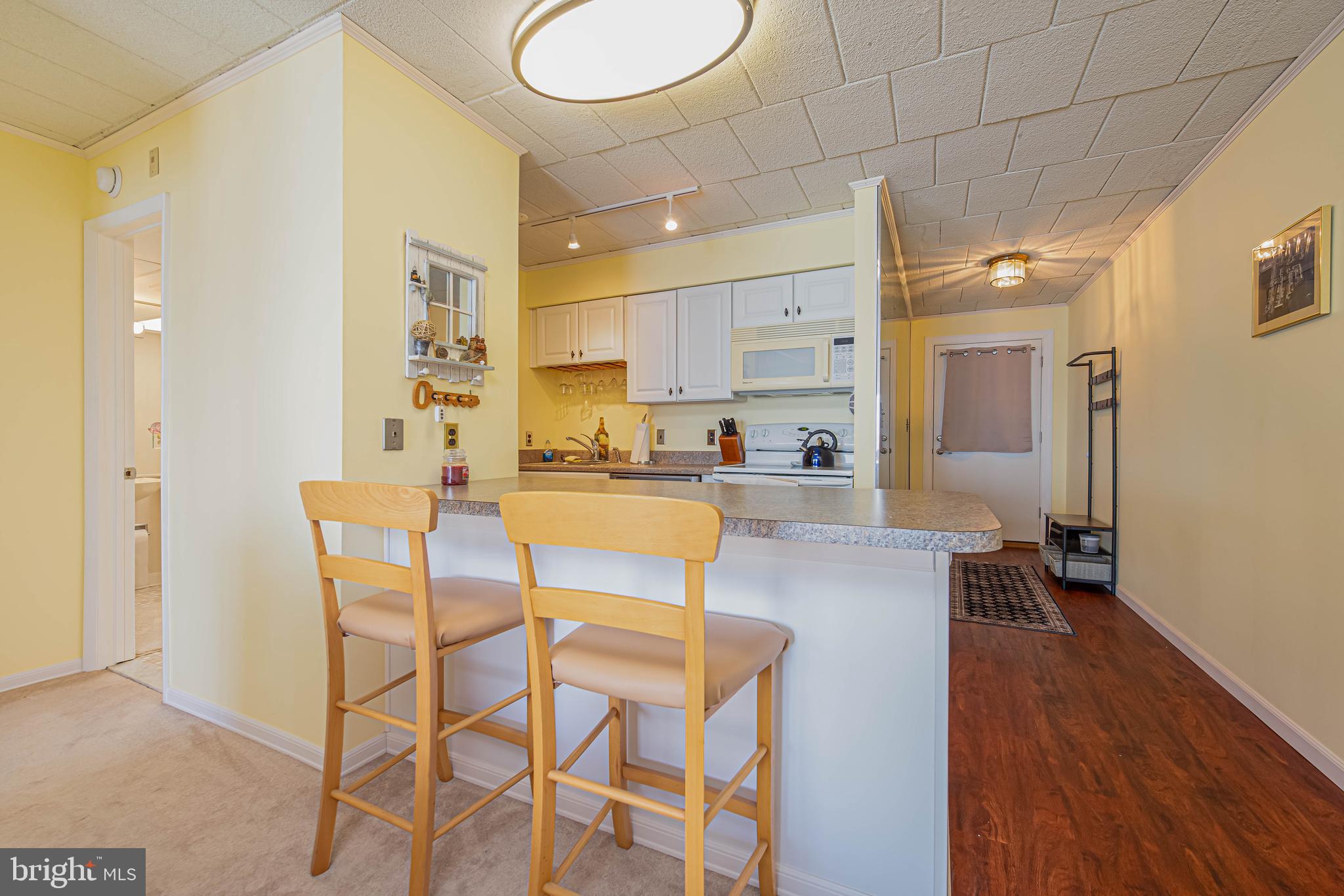 745 Mooring Road, Unit 406 Ocean City, MD 21842 - Photo 9 of 24 a view of a kitchen and kitchen island