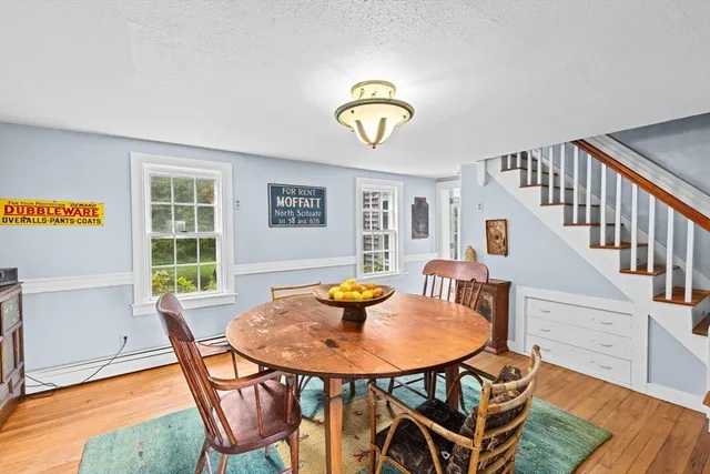 a view of a dining room with furniture and a window