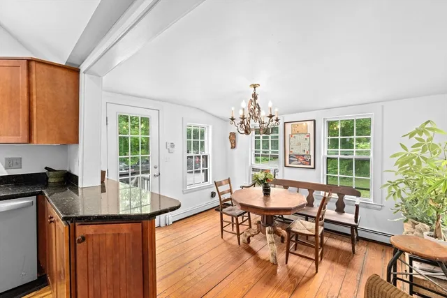 a dining room with furniture a window and wooden floor