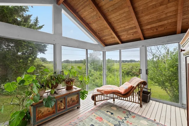 a balcony with furniture and a potted plant