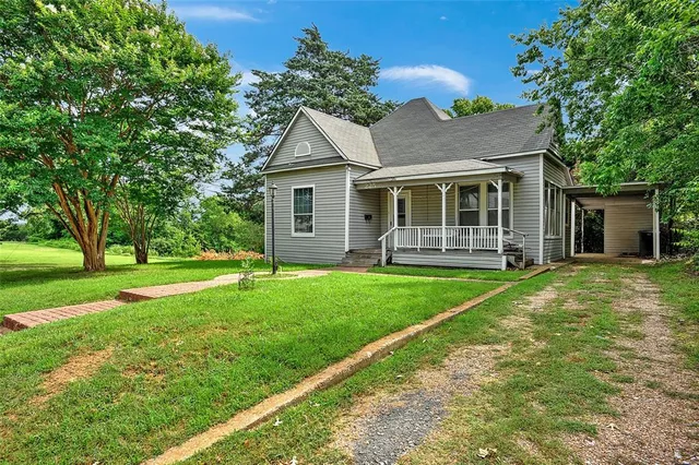 a front view of house with yard and green space