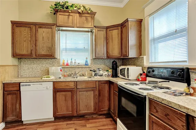 a kitchen with a sink stove and cabinets