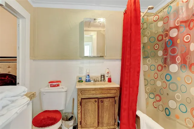 a bathroom with a sink toilet vanity and tub