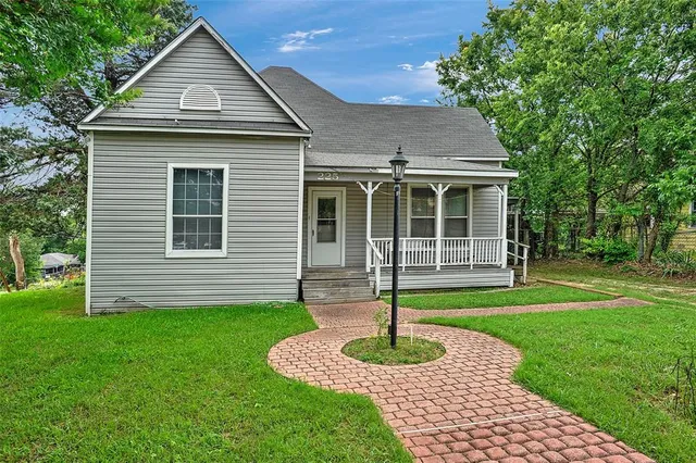 a front view of a house with garden and porch