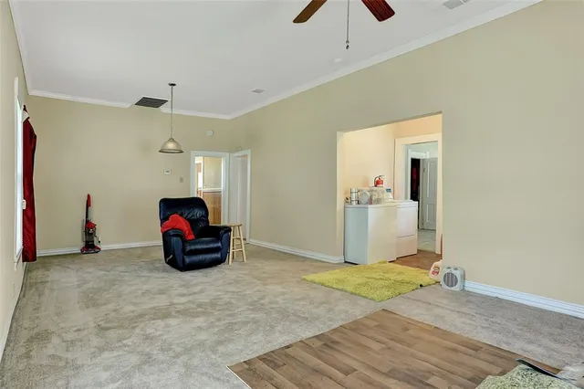 a view of a livingroom with a fireplace and a chandelier