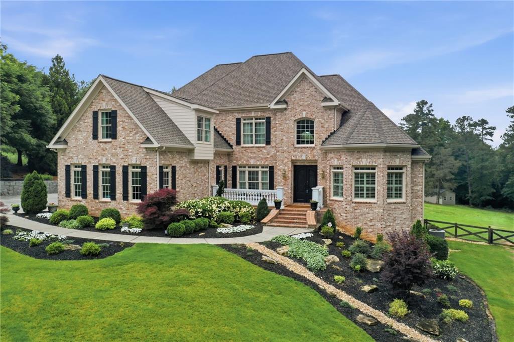 2950 Callie Still Road Lawrenceville, GA 30045 - Photo 3 of 77 a front view of a house with a garden