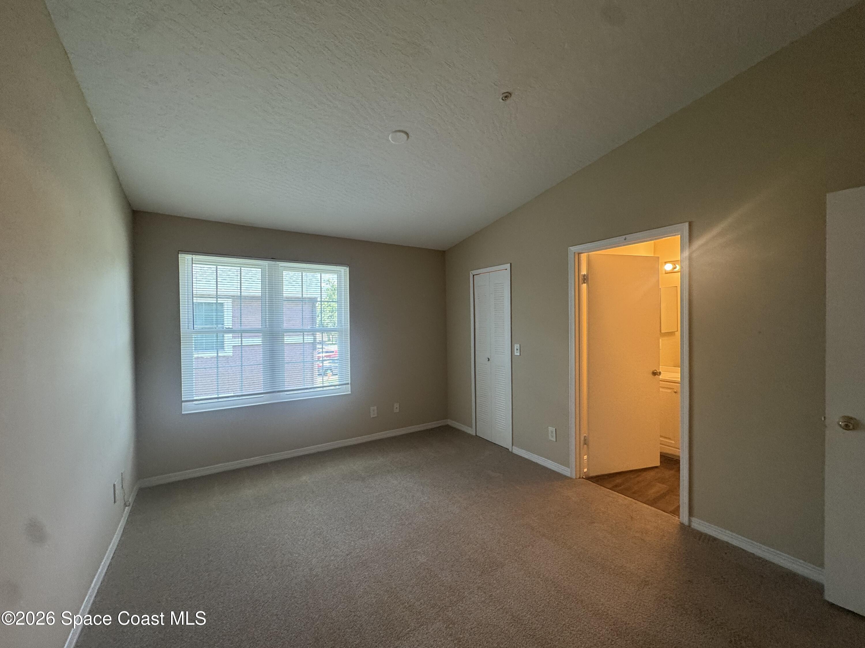 7667 North Wickham Road, Unit 1415 Melbourne, FL 32940 - Photo 12 of 23 Primary bedroom